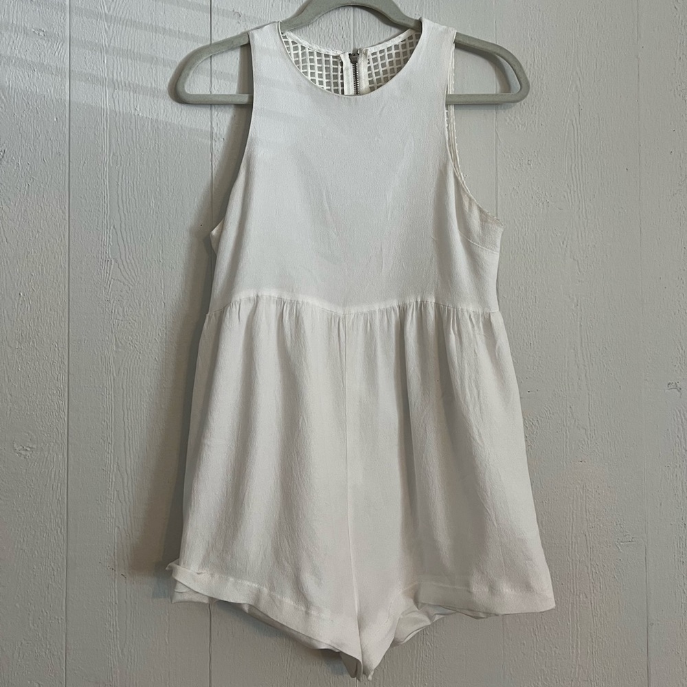White babydoll smock romper with box detailing and zipper